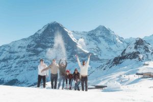Family photo shoot in the snow on Männlichen mountain near Interlaken, Switzerland
