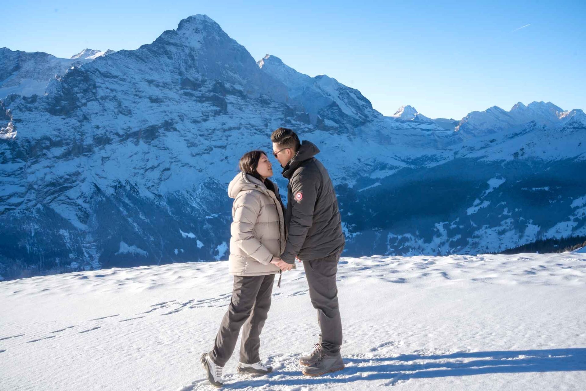 A surprise marriage proposal on Grindelwald First mountain. An engagement proposal with the Eiger mountain as a backdrop.